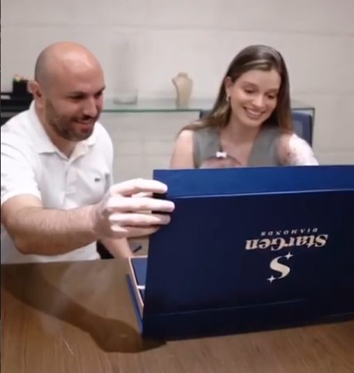 A couple opening the StarGen box with the diamond made from their daughter’s umbilical cord